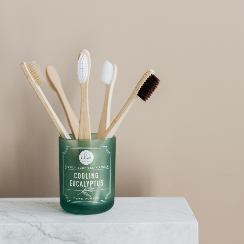 bamboo toothbrushes in glass jar